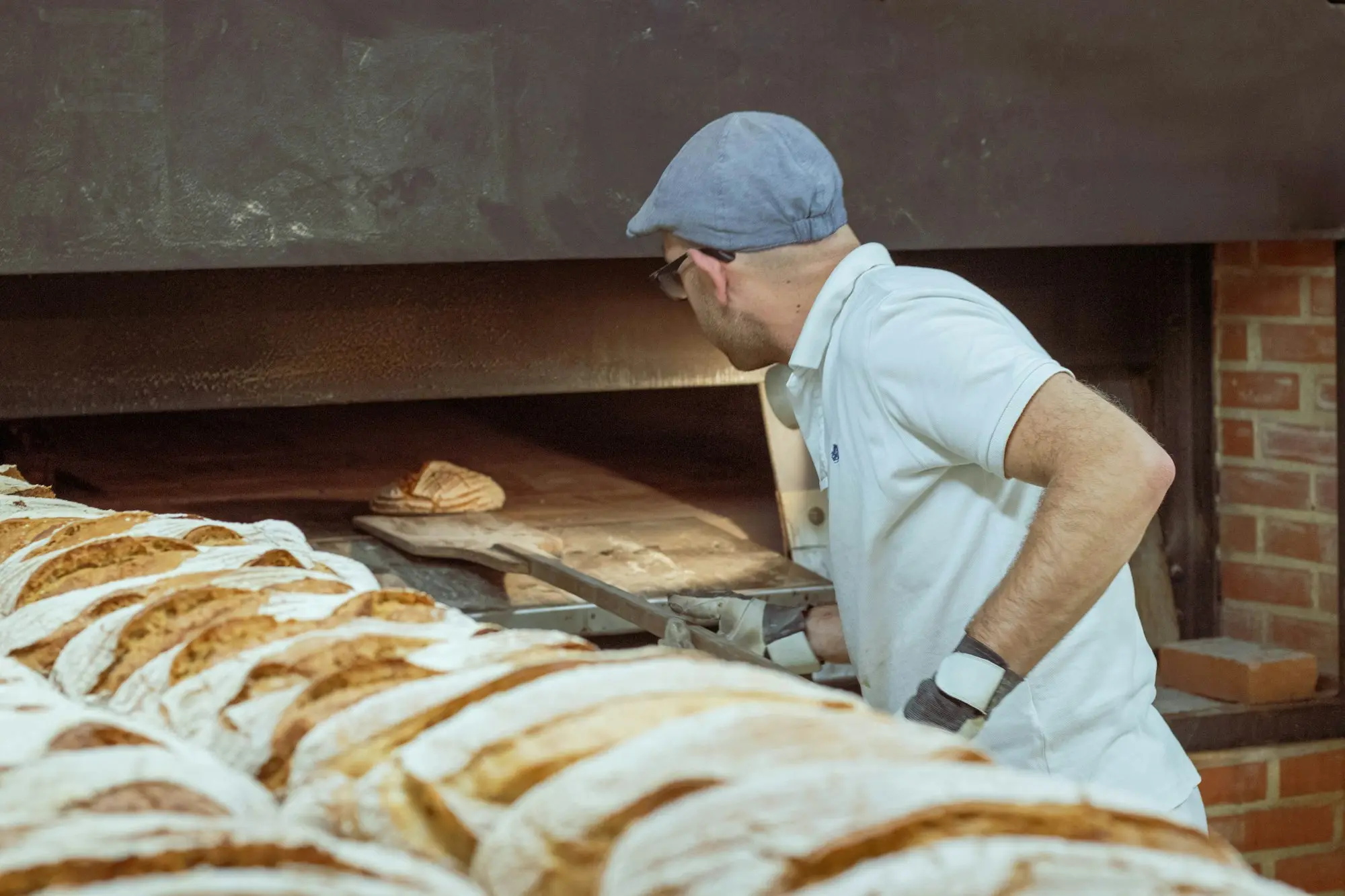 Bakers shaping loaves early in the morning in a Hobart bakery