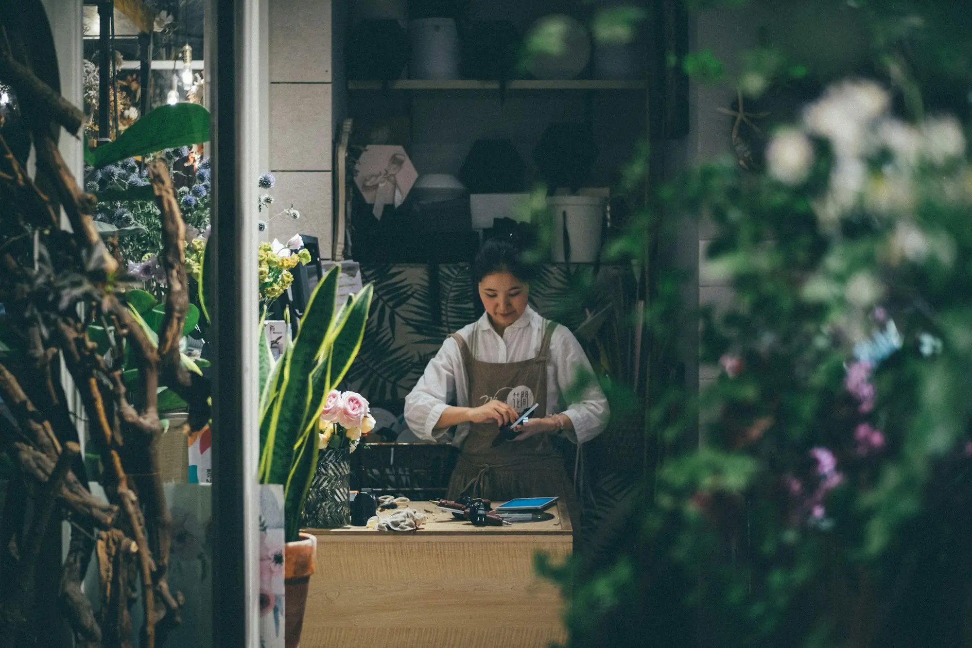 Florist arranging bunches in a quiet shop on a weekday morning