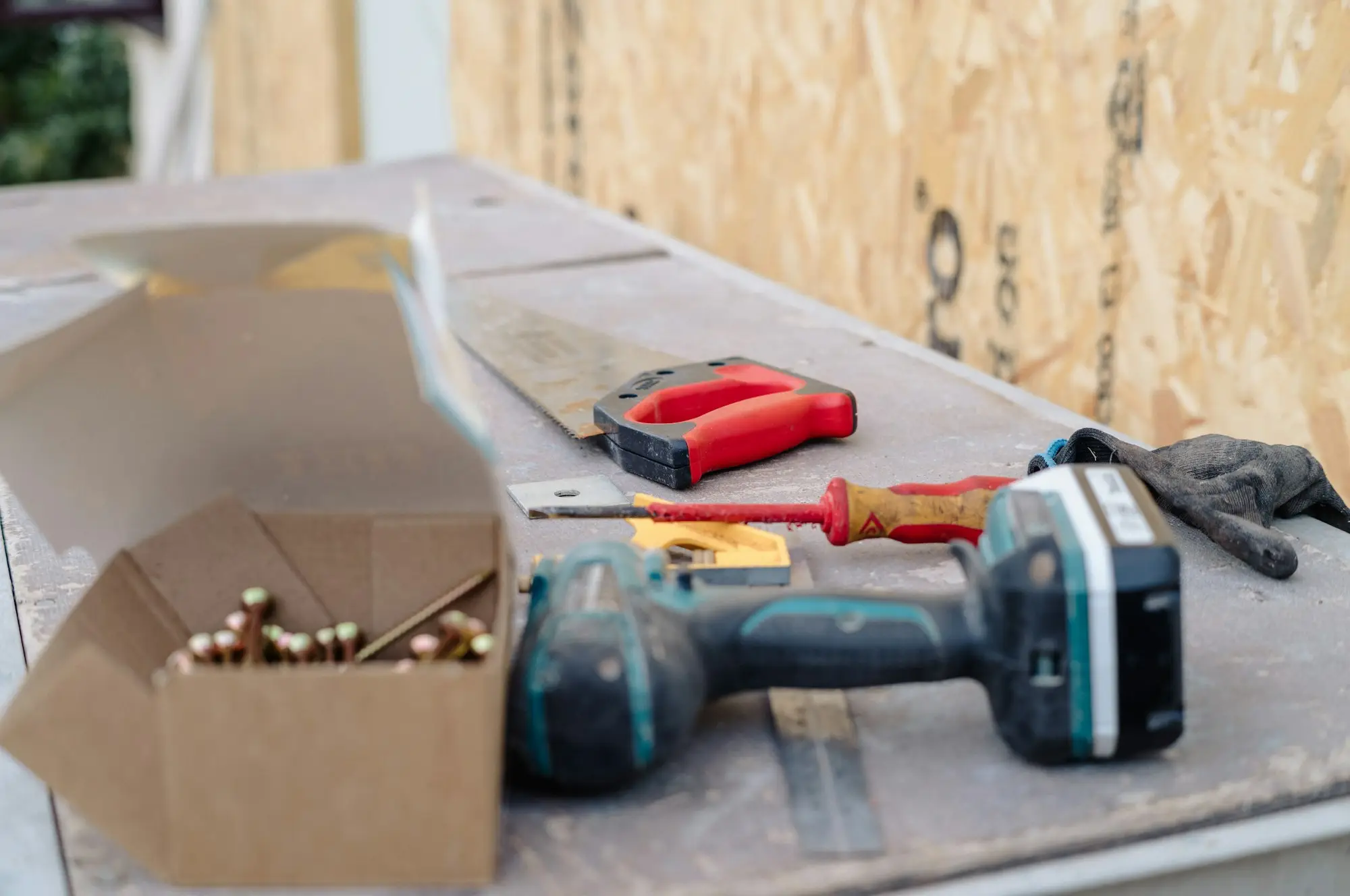 Tradesperson loading tools into a work ute on a Geelong building site